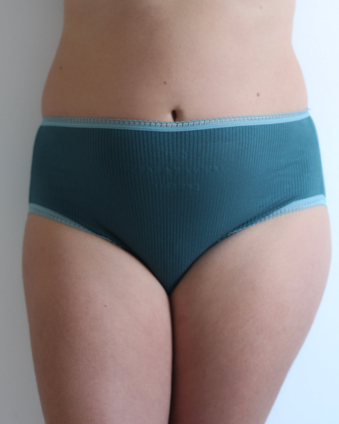 Model wearing Knickerhood's teal emotionally supportive knickers, posing confidently
